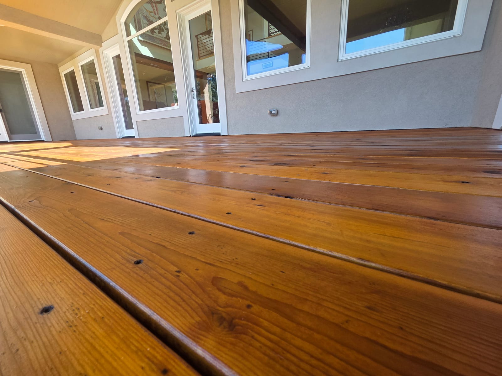 Close-up of a finished deck showing even penetrating oil stain absorption